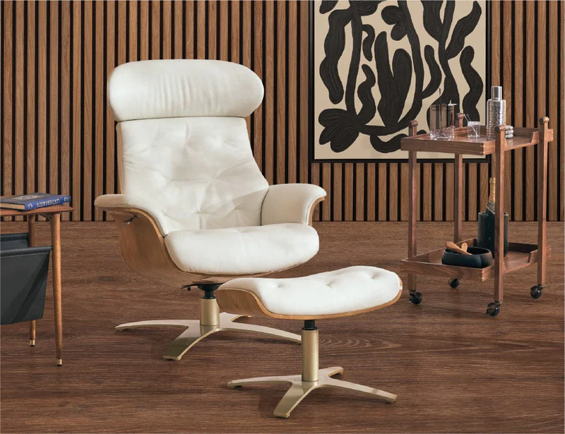 White lounge chair and ottoman in a warm wood-paneled room