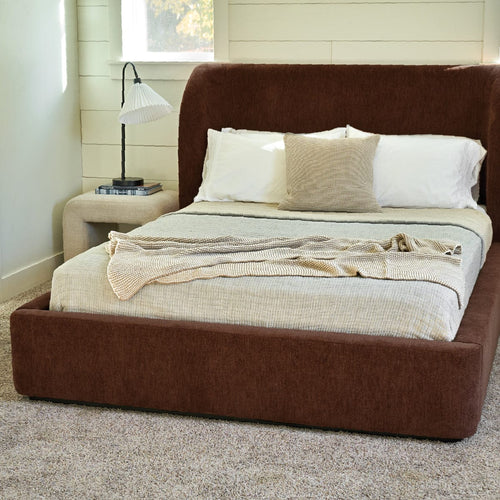 Bedroom with upholstered bed and layered bedding